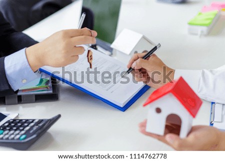 Real estate broker and customer signing a contract. Trading house for rent and insurance