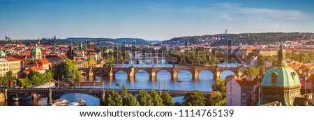 Scenic spring sunset aerial view of the Old Town pier architecture and Charles Bridge over Vltava river in Prague, Czech Republic Royalty-Free Stock Photo #1114765139