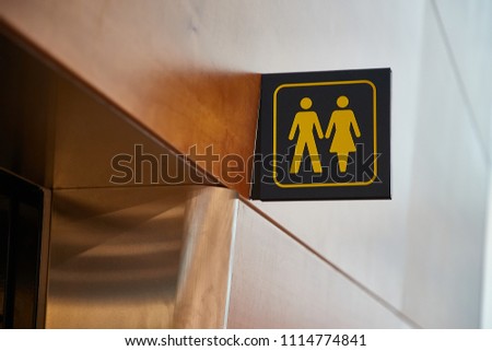 Toilets sign in a building corridor