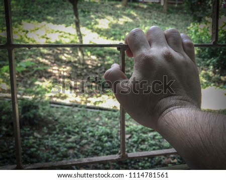Hand holding on chain steel.