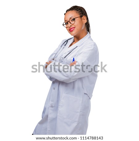 Portrait of a young black doctor woman crossing his arms, smiling and happy, being confident and friendly