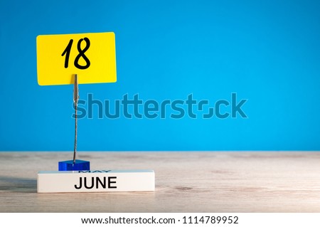 June 18th. Day 18 of june month, calendar on table with blue background. Summer time, empty space for text or template Royalty-Free Stock Photo #1114789952