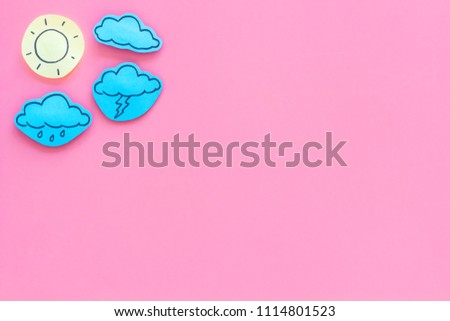 Weather forecast concept. Modern weather icons set on pink background top view copy space