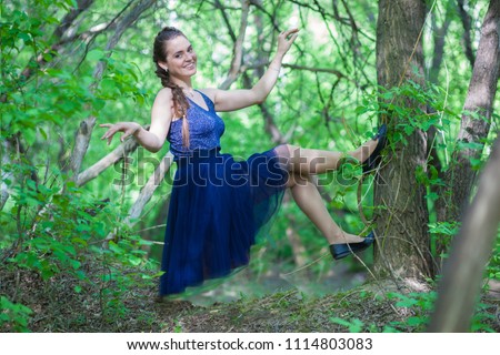 fairy forest. tooth Fairy. A beautiful girl in a blue dress walks the trees. Forest Elf