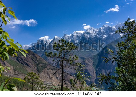 Beautiful scenery hiking trail path of Tiger Leaping Gorge with Jade Dragon snow mountain in Background, Lijiang, Yunnan, China