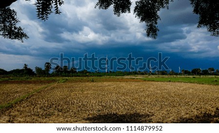 Wind Farm Plant with Dark Black Rain Clouds surrounds and thunder rumbles