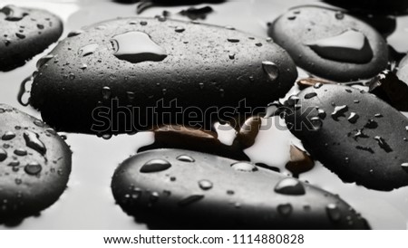 Black wet pebbles background wallpaper