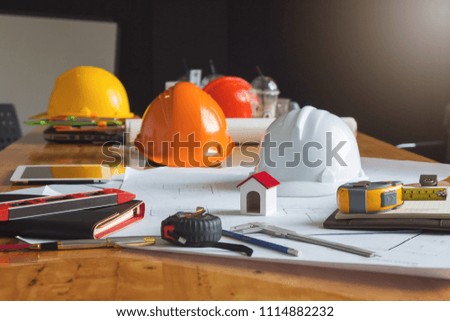 Engineer and Architect concept, Engineer Architects and real estate agent office desk with blueprints
