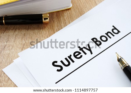 Surety bond form and pen on a table. Royalty-Free Stock Photo #1114897757