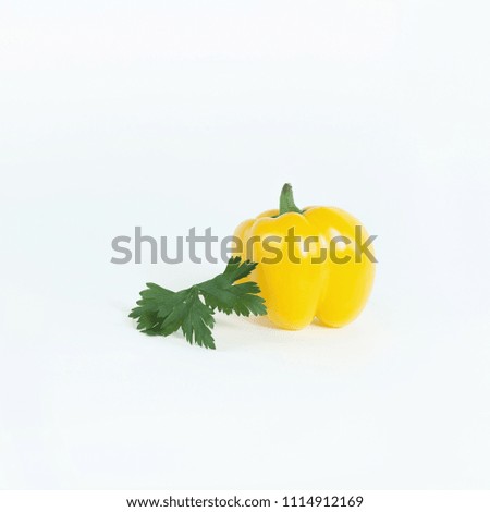 yellow bell pepper, and a sprig of parsley .isolated on a white