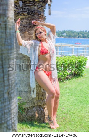 Luxury Resort. Woman Relaxing at sea. Beautiful Happy Healthy Female Model Enjoying Summer Travel Vacation, Looking At Sea View. Summertime Recreation, Relax And Spa Concept
