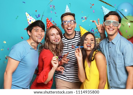 Happy young people celebrating birthday together on color background