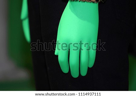green hand on animal fur clothes detail close up