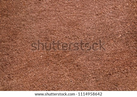 Brown sandstone wall texture details. Close-up photo of gritty background. Horizontal orientation