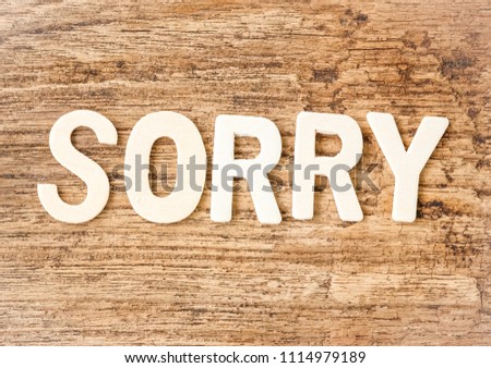 word SORRY made by wooden alphabets on wooden background, apology concept