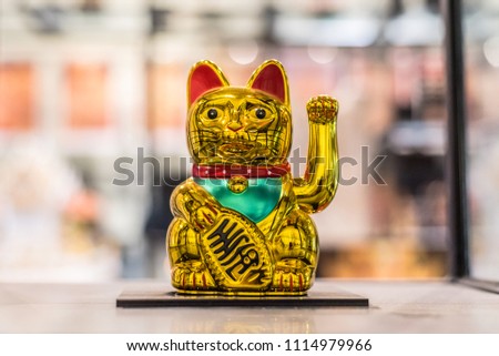 Maneki Neko, Japanese lucky cat, figurine golden cat brings good luck Royalty-Free Stock Photo #1114979966