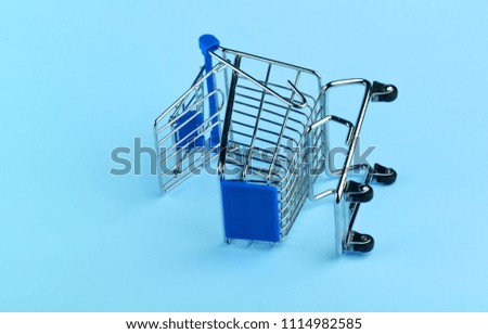 Empty shopping cart on blue background