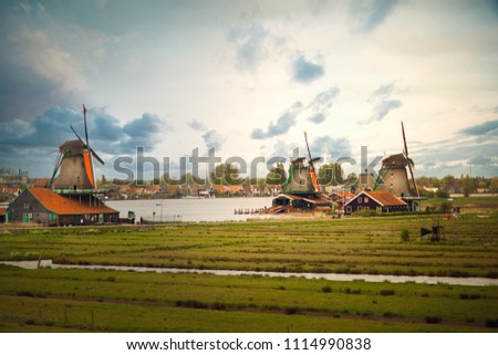 Amsterdam. Zaanse Schans. Mills. River and houses. Field and grass. Netherlands. Spring. 