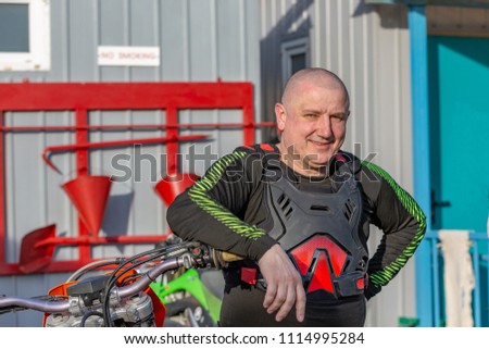 portrait of an elderly biker dressed in protection, closeup