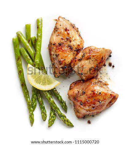 roasted chicken meat and grilled asparagus isolated on white background, top view Royalty-Free Stock Photo #1115000720