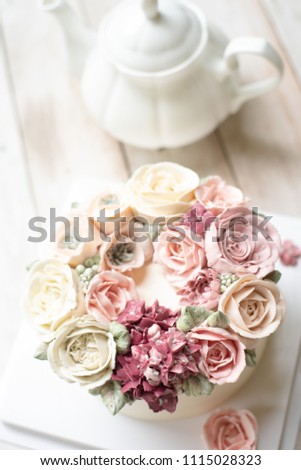 Buttercream flower cake on wooden background