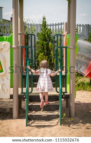 Active little girl playing on a playground