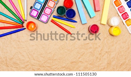 School tools on the rumpled paper.
