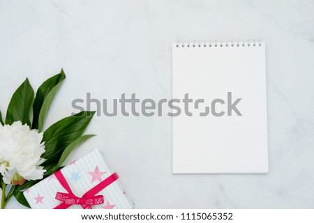 Composition with flowers and notebook on white background. Mock up for your design. Flat lay.
