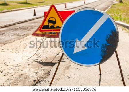 Road signs detour on the left road repair