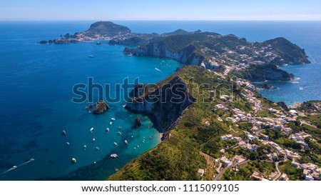 Aerial view of Ponza, island of the Italian Pontine Islands archipelago in the Tyrrhenian Sea, Italy. On the island there are few houses between the Mediterranean vegetation and the sea. Royalty-Free Stock Photo #1115099105