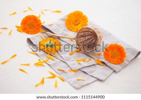 Herbal tea with marigold flowers on the table - herbal medicine