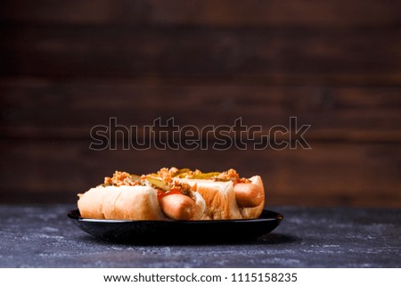 Picture of hotdogs on black plate