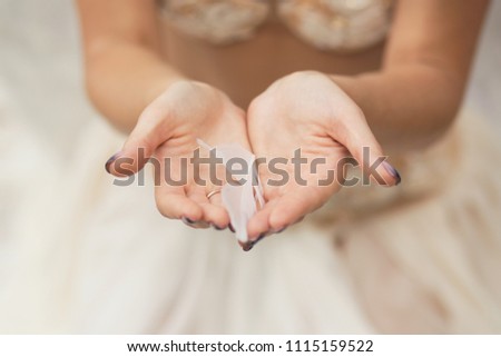 white feather in female hands