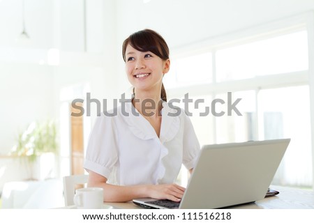 Beautiful business woman using a laptop computer. Portrait of asian.