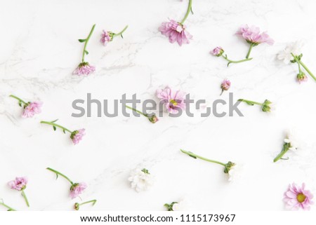 Floral pattern with tender pink and white flowers arranged as a flatlay on white background