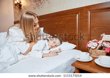 The loving mother awakes the sleeping daughter
