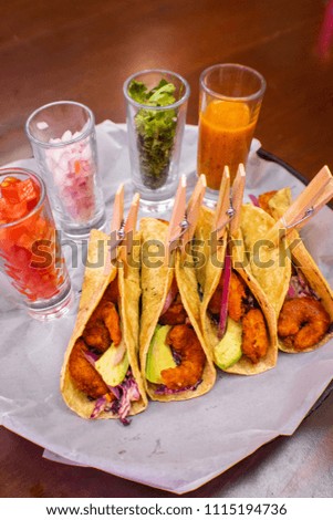 Shrimp tacos with closed with a wooden clothes hook, Mexican restaurant.