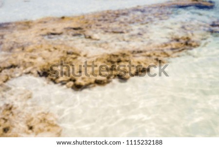 Defocused background of white sandy beach in Salento, Italy. Intentionally blurred post production for bokeh effect