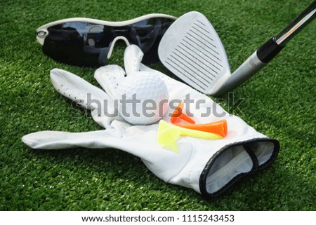 Golf equipment. Golf ball on the green grass in beautiful golf course at sunset background.