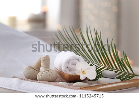 Beautiful spa composition on massage table in wellness center Royalty-Free Stock Photo #1115245715