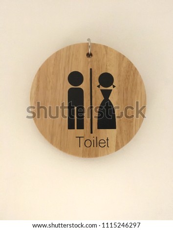 Sign of toilet man and woman on wooden round