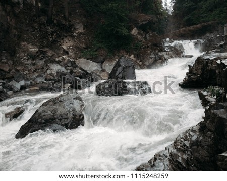 
river in the mountains. waterfall through the rocks. 
Washington