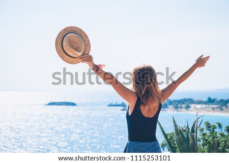 Young woman enjoying the view by the sea