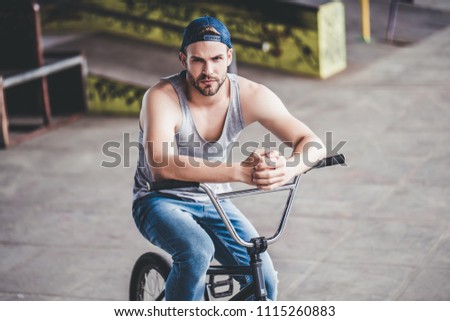 Young man in skatepark. Male teenager with BMX bike. Professional BMX rider.