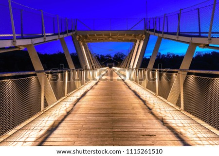 Walking bridge lit up at night