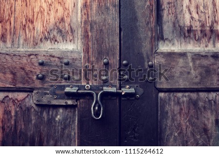 Antique door latch on old wooden door.