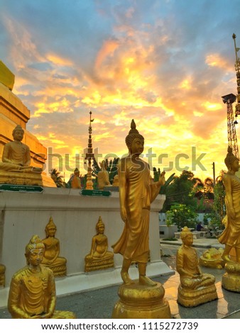 Buddhism statues with light of the sun background.