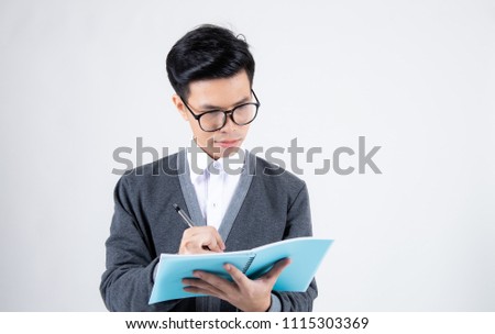 Hipster man is wearing winter shirt and glasses reading a book isolated on white background,So nerd and stylish,Young handsome student is concentrated on studying,Successful man in a casual outfit,