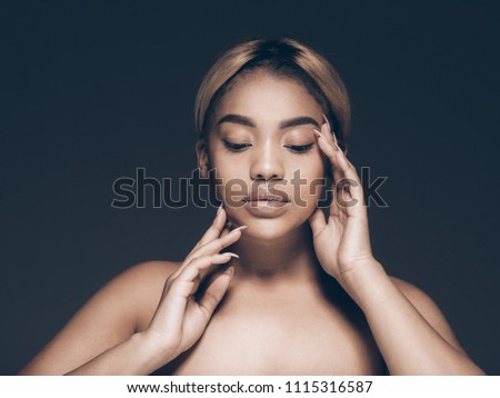 Afro woman black skin face closeup over gray background beauty