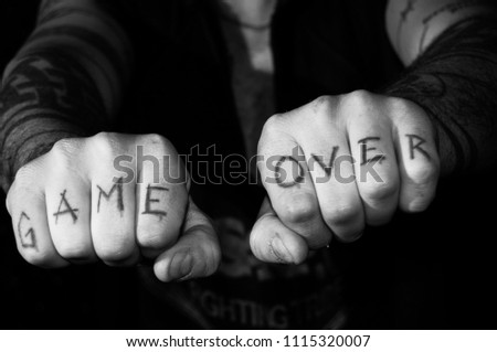 hands with tattoo game over